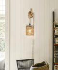 Straight Up Chic Boho Woven Rattan Plug In Pendant Ceiling Light casting dreamy Art Deco wall shadows in a cozy room.