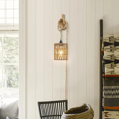 Straight Up Chic Boho Woven Rattan Plug In Pendant Ceiling Light casting dreamy Art Deco wall shadows in a cozy room.