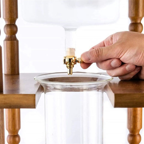Top Shelf Stainless Steel Cold Brew Dripper With Heavy Duty Premium Borosilicate Glass for smooth iced coffee, gold valve in use.