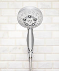 Rio Multi-Function Handheld Shower Head With Hose, Polished Chrome Finish, 5 Spray Settings, Detachable Design against tiled wall