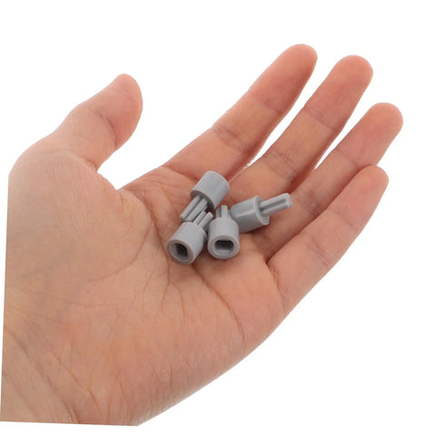 Four Pack Motor Adapter Wheel Connectors in hand for DIY robotics and smart car builds