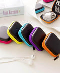 6 Pack Tough As Nails PU Hard Shell Earbud Cases Small Square Zipper Carry Pouches in various colors on a table.