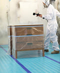 Person in protective gear painting near Aqua Shield Surface Protector 10 Mil 36 Inch By 100 Foot Heavy Duty Protective Film on floor