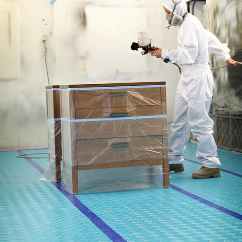 Person in protective gear painting near Aqua Shield Surface Protector 10 Mil 36 Inch By 100 Foot Heavy Duty Protective Film on floor