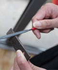 Using a mini file from the Ten Piece Needle File Set With Pro Grade Hardened Alloy Steel Mini Files Including Tapered Round Half Round Barrette Crossing Knife Warding Square Three Square Five And A Half Inch Length Dipped Handles And Dust Free PVC Pouch For Easy Metal Shaping on metal surface