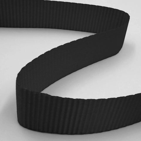 Close-up of a black strap from Cambuckle Tie Down Straps 1 Inch By 10 Feet Red 900 Pound Break Strength 8 Pack with textured surface
