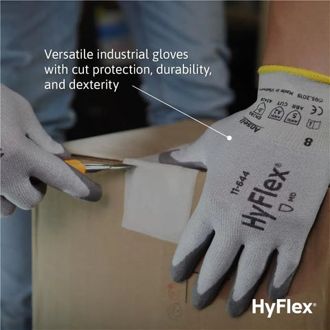 Person using HyFlex 11-644 Cut-Resistant Work Gloves With Ergonomic Fit And Low Palm Weight For All Day Grippy Feel, cutting cardboard.