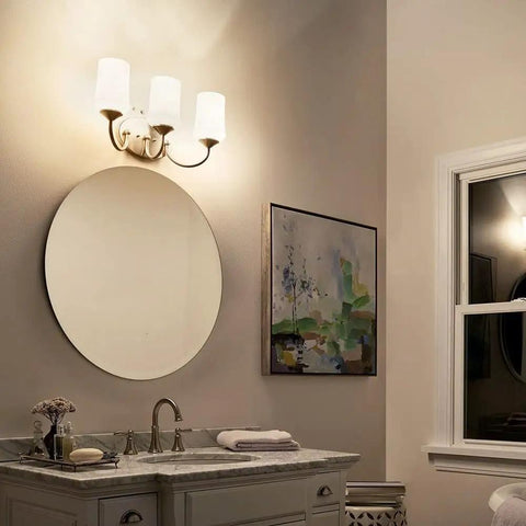 Aubrey 21 Inch 3 Light Vanity Light With Satin Etched Cased Opal Glass In Olde Bronze Finish above round mirror in bathroom