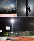 150W LED Flood Light Outdoor 15000 Lumens on volleyball court and basketball court during night with silhouette of worker