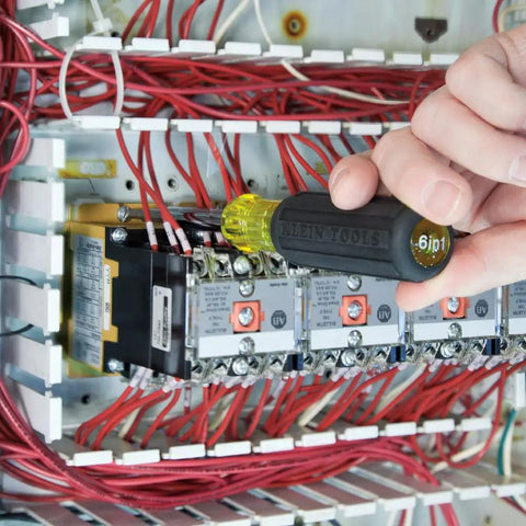 Using Multi Bit Screwdriver And Nut Driver 6 In 1 Set With Extended Reach installing in electric panel, showing slim grip handle.