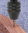 Close-up of a drill bit from the 57Pcs Pin Vise Hand Drill Bits Set for Crafting and DIY Projects drilling into wood surface.