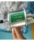 12 Volt Universal Electric Fuel Pump HEP02A Low Pressure Inline Assembly with green label showing 'IN' and 'OUT' directions.
