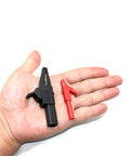 Hand holding large and small alligator clips from the All In One 10Pcs Test Leads Kit With Double Insulated Leads, 1000V CAT III, 14AWG.