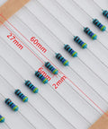 Close-up of resistors with measurement details from 600Pcs One Quarter Watt 30 Value 1% Precision Metal Film Resistor Kit Set 10 Ohm To 1 Mega Ohm For Electronics DIY Projects Pro Repairs And Hobbyist Experiments.