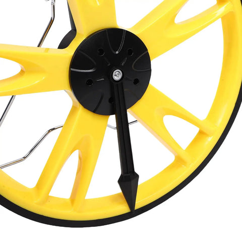 Close-up of Marhynchus Telescopic Measuring Wheel for Precise Measurement black and yellow wheel with arrow tip.