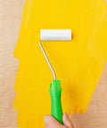 10 Pack Mini Sponge Rollers Hella Perfect For Wall Touch Ups And Texture Work Featuring Tough Plastic Grips And Absorbent Sponge Cores For Total Control On Any Paint Job Built To Last Through Many DIY Sessions Creating A Badass Finish In Seconds using a mini roller on yellow paint.