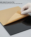 Four-pack black acrylic sheets, 12×16 in, 1/8 in thick, protective film being peeled.