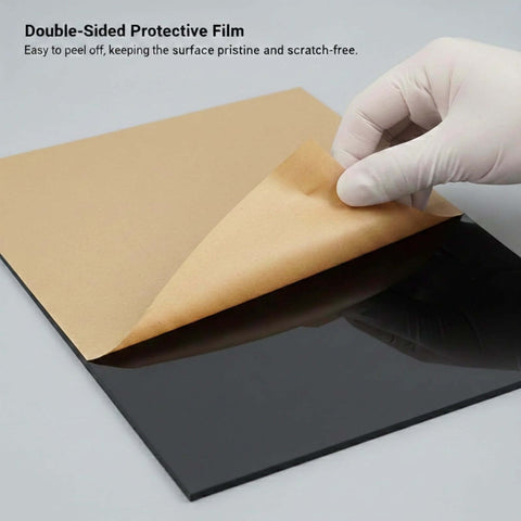 Four-pack black acrylic sheets, 12×16 in, 1/8 in thick, protective film being peeled.