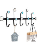 Sturdy Rust Resistant Metal Coat Rack Wall Hooks With Lowkey Luxe Gold Finishing hangs bags and a sign in modern entryway.