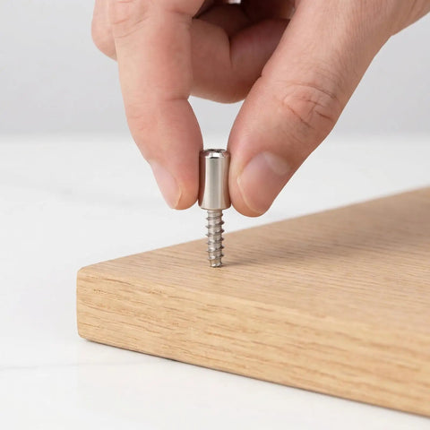 Close-up of hand inserting screw from Heavy Duty Cabinet Shelf Peg Set With 150 Self Tapping Shelf Pins And 150 Sleeves 0.3 Inch