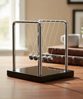 5 Ball Newton's Cradle Balance Pendulum With Solid Wood Base Desktop Fidget Kit For Calming Focus At Home Or Office Decor A Fun Science Physics Toy For Adults shown on wooden desk in office setting