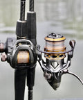 Real Smooth Spinning Fishing Reel Size 200 Decked Out With 10 Plus 1 Bearings And 6.2 To 1 Gear Ratio on fishing rod near water