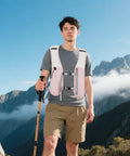 Person wearing Ultra Lightweight Running Hydration Vest With Adjustable Straps Bladder Compatible Chest Pack during hike in mountains.