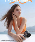 Person holding a Handheld Portable Fan With 6 Speeds, Tiny But Mighty Mini Personal Fan, 5000mAh Rechargeable Battery outdoors.