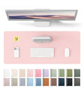 Leather Desk Protector Mat For Office And Home Large Mouse Pad Non Slip PU Leather Blotter Waterproof Writing Pad Light Pink 23.6 By 13.8 Inches Perfect For Your Laptop Keyboard And Desk Setup, shown with desktop accessories.