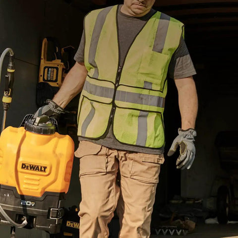 Man holding 20V Max 4 Gallon Lithium Ion Cordless Backpack Sprayer Kit With 2Ah Battery, heavy duty hose in a garage