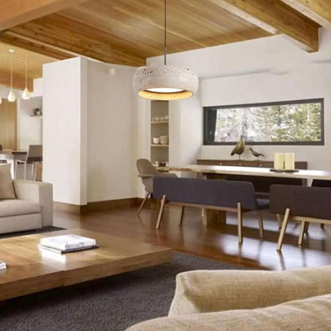 Modern Dome Yellow Travertine Pendant Light over a dining area showcasing a natural stone design in a cozy living space.