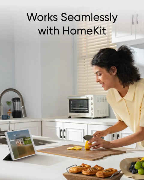 Woman using tablet in kitchen demonstrating Outdoor Solar Powered Wireless 4K Security Camera Kit With MaxColor Night Vision
