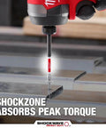 Milwaukee Shockwave drill bit in red and silver, close-up view of bit drilling into metal