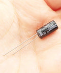 Close-up of a single capacitor from the Through Hole Electrolytic Capacitor Assortment Kit, 120 Pcs Total, 12 Types, 0.22uF To 470uF Range.