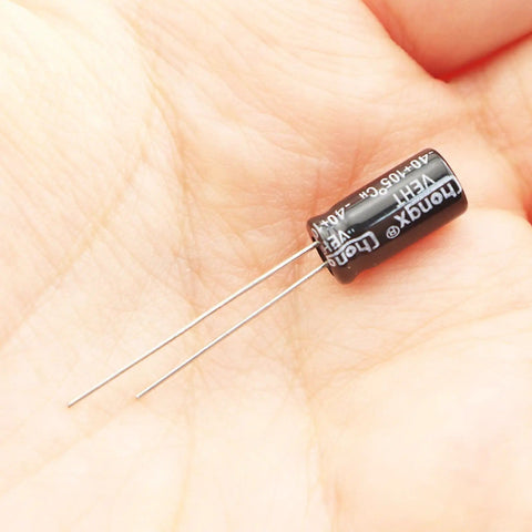 Close-up of a single capacitor from the Through Hole Electrolytic Capacitor Assortment Kit, 120 Pcs Total, 12 Types, 0.22uF To 470uF Range.