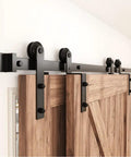Smooth Riding Single Track Bypass Sliding Barn Door Hardware Kit For Two Doors Covers Five Feet Of Wall Space Saves Square Footage In Cramped Rooms With Upgraded Compact Frame And No Sweat Step By Step Install Walkthrough, black steel track and rollers on wooden doors.