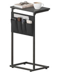 C Shaped End Table With Sliding Tray Under Sofa 28 Inch High Side Table With Storage Bag Black in living room setting with books and coffee
