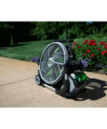 Image of Go To Outdoor Mist Cooling Fan With 18 Inch Blade, 5 Speed Settings, Delivers Up To 5,000 CFM, Two Misting Modes, Telescopic Handle And Rolling Wheels, Battery And Charger Not Included, Your Backyard Cooling Buddy on a patio.