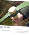 Close-up of Durable Steel Garden Pickaxe Handle Handheld Tool For Soil Digging Weeding Root Removal And Transplanting in use outdoors.