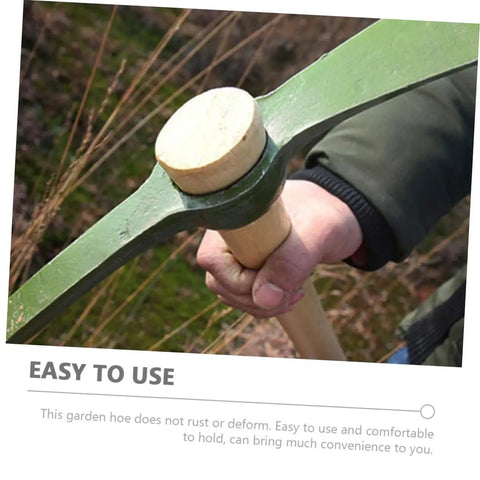 Close-up of Durable Steel Garden Pickaxe Handle Handheld Tool For Soil Digging Weeding Root Removal And Transplanting in use outdoors.