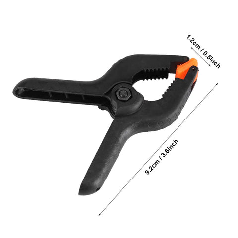 3 Inch Plastic Spring Clamps With Killer Anti Slip Grip Heavy Duty Woodworking And Backdrop Clips Hella Handy For Crafts Home Diy Total Flexible Tool Built Tough For Quick Projects black plastic clamp with orange detail and ridged grip
