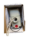 Electric proportional valve in box, gray plastic body with red port and attached wiring