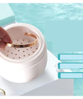 Premium Portable Ultrasonic Cleaner For Jewelry And Watches with golden bracelet inside, compact design for gentle cleaning.