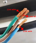 Close-up of live wires in electrical cables showing copper strands, indicating proper wiring connections.