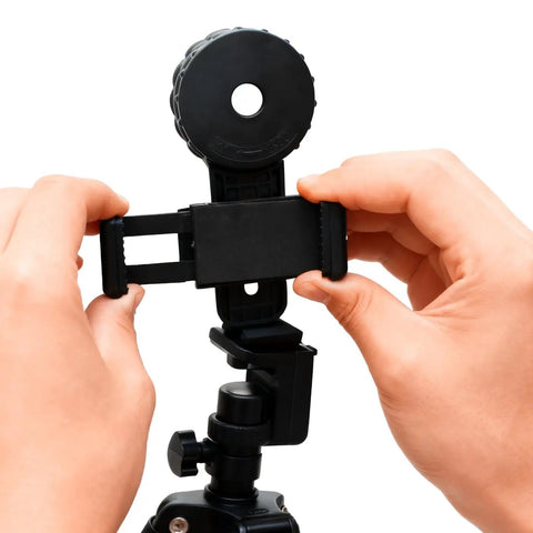 Hands adjusting Universal Binocular Phone Adapter With 360-Degree Rotation And Clip Lock High-Strength Clamp Fits 16-50mm Eyepieces.