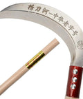 Close-up of multipurpose grass sickle with hardwood handle and manganese steel blade, designed for weeding vines and small shrubs.