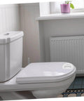 Bathroom scene with a self-adhesive handle on a toilet lid, highlighting the Two Pack Self Adhesive Cabinet Handles And Sliding Door Pulls.