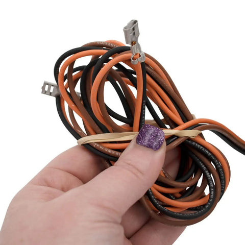 Close-up of hand holding wiring for 1/8 HP HVAC Condenser Motor For Central AC, 1 Phase, 1075 RPM, 208 To 230V setup.