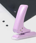 Pro Grade 40 Sheet Single Hole Punch With Non Slip Base 5.5mm Hole Adjustable Punch Position, purple tool on white background