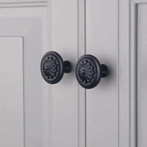 Matte Black Round Cabinet Knobs 10 Pack Zinc Alloy With Floral Design 1.4 Inch Diameter Drawer Knobs With Included Screws For Cabinets And Dressers Dope Hardware To Level Up Your Furniture on a white cabinet